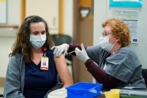 Nurses and healthcare workers share jubilant vaccine photos using hashtag #covidvaccine